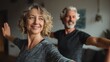 © Johannes - fit middle aged 50s family couple doing fitness yoga morning exercise at home sporty healthy old mature man and woman training together standing in living room active seniors sport stretching no logo