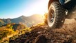 © Farzan - Off-Road Adventure: Tire Kicking Up Dust on Mountain Trail at Sunset
