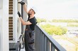 © Serhii - Young man repairman checking an outside air conditioner unit