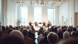 blurred image of string quartet performing for audience