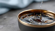 © Milos - A close-up of rich syrup glistening with golden particles, showcasing the smooth texture and alluring shine, ideal for culinary or artistic projects and stock imagery.