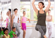 © JackF - Professional female dance instructor guiding group of enthusiastic teenage students, demonstrating ballet movement techniques in sunlit choreography studio