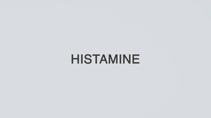 Histamine concept word hand holding stethoscope on white background for allergy monitoring, diagnosis, treatment, prevention, wellness, and immune system awareness