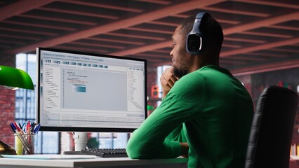 freelance developer writing code in a modern programming language. young man analyzes big data, algo