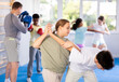 © JackF - Girls and boys learns to do power grip with trainer during a self-defense lesson in the gym
