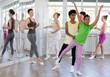 © JackF - Young ballet students, positive African American teen girl and boy, learning paired technique in dance school under guidance of female teacher in light-filled studio