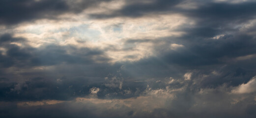 Wall Mural - Evening sunset sky background with bright dramatic clouds.