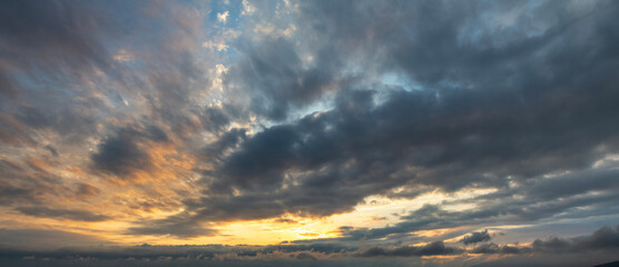 Wall Mural - Evening sunset sky background with bright dramatic clouds.