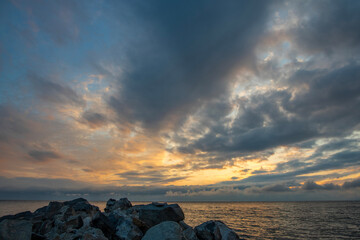 Wall Mural - beautiful sunset with dramatic clouds over the lake and mountains.