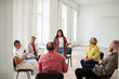 © Marko Geber - Group therapy session with diverse people sitting in circle and sharing experiences
