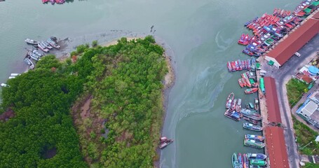 Wall Mural - A fleet of fishing boats creates gentle ripples in the dock, The coastal landscape of Phuket, It’s a scene of motion and stillness, where the economy and environment coexist in visual harmony.