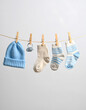© Nieke - Baby Clothes Hanging on a Clothesline, Blue Hat, Socks, Newborn Concept, Baby Shower