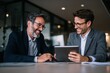 © ttonaorh - Businessman and manager discussing business plans on a digital tablet in the office.