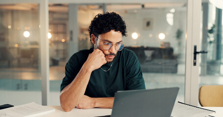 Laptop, thinking and web coding with man in office at night for problem solving or solution. Business, design and computer with programmer in workplace for evening maintenance or troubleshooting