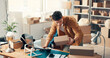 © FlexiTon/peopleimages.com - Laptop, ecommerce and man with box in office for stock, inventory management and reading label. Computer, distributor and shipping package for supply chain, order and sales info in small business