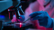 © Curioso.Photography - Scientist in gloves using tweezers and a microscope with red light to examine a sample, symbolizing laboratory research, science, and medical innovation.