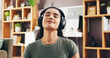 © peopleimages.com - Zen, smile and headphones with woman in home for streaming service, wellness podcast and mindset. Relax audio, meditation guide and peace sound with person in living room of apartment for music