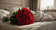 © Marina - Large lush bouquet of red roses on messy unmade bed after romantic night