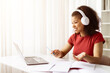 © Anastasiya - Smiling African American woman with headphones having online video call at home. Remote learning, freelance work or digital communication concept in modern lifestyle