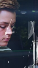 Sticker - animation of lights over group of diverse teenager students using computers