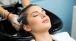 © REMIN KHATUN - Woman getting her hair washed in a salon with eyes closed and relaxed face