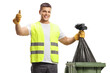 © Ljupco Smokovski - Waste collector holding a bin bag and gesturing thumbs up