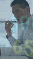 Wall Mural - animation of digital icons over businessman using tablet
