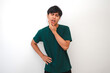 © Muhammad Alimaki - Young Asian man with a painful expression touching his jaw, possibly due to toothache, isolated on white background. Perfect for dental care, health, or medical advertisement concepts