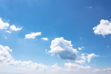 Wall Mural - white fluffy clouds on the azure blue sky. cumulus cloudscape in bright light in summer. weather background for vacation on a sunny day. cloudy atmosphere brings fresh air concept
