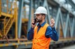 © Pete - Male locomotive engineer in hard hat, safety vest speaks on radio, coordinating train operations, staff. Manager oversees schedules, work orders on rail transport site. Ensures safety, efficient