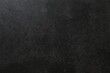 © Sunlight - Dark grey textured concrete wall background