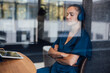 © Westend61 - Businesswoman with eyes closed seen through glass