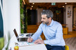 © Westend61 - Businessman writing ideas on paper at co working space