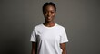 © Lari - Black woman with braided hair wearing a white t shirt for mockups stands in front of a gray background smiling slightly