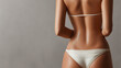 © Nadia - Tanned female back in white bikini bottom showing slim waist and wet skin