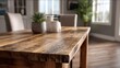 © Tiwakeat - Close up of a rustic distressed wooden dining table with a succulent plant in a modern home
