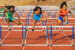 © Connect Images - Three athletes hurdle on a red track under sunny skies, displaying strength and determination. USA