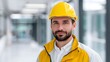 © pkproject - Construction worker wearing a yellow safety helmet indoors