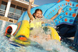 © New Africa - Happy girl on slide at water park. Summer vacation