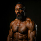 Muscular Power: Portrait of a muscular individual, showcasing impressive physique, strength, and body-building prowess, set against a dark background.