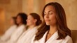 © Phongchaloem - A serene spa scene featuring a woman in a robe, enjoying a moment of relaxation amidst others, all focusing on wellness and tranquility.