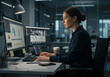 © Agus Ismanto - Woman working at a computer in an office, focused on the screen with charts and code.