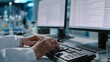 © Justlight - Focused medium shot of a lab technician verifying chatbot medical notes hands typing on keyboard with outoffocus monitors displaying transcript data.