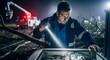© Cliff - Electrical engineer technician working night shift with flashlight trying to restore power supply during an outage