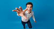 © Dazz - Excited young man reaching hand forward to grab something. Happy businessman offering a helping hand or taking something. Man's hand reaching out for help, connection, or opportunity.