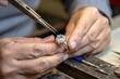 © stockimgahnaf - Jeweler polishing a diamond ring with precision and care