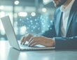 © RAYNAN - Artificial intelligence concept with glowing neural network connections overlaying a businessman working on laptop.
