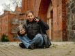 © tan4ikk - Girl Taking A Selfie In Front Of An Old Tower In A European City