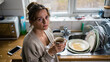 © olgakris - Tired woman holding coffee cup in messy kitchen, overwhelmed domestic moment, real life fatigue and household stress