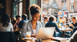 © Earthen Stock - Woman working on a laptop in a busy cafe, remote work or freelance